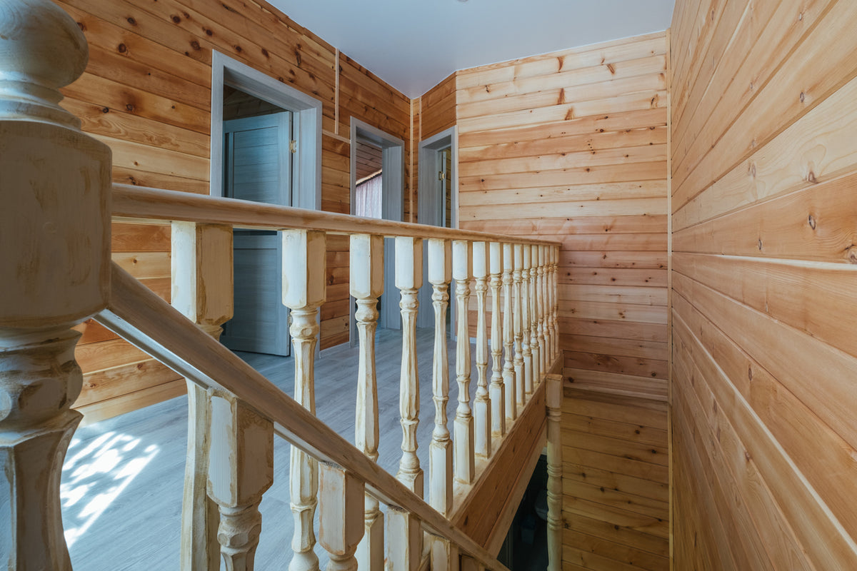 Rénovation intérieure d'un chalet en bois avec escalier et mezzanine à Combloux en Haute-Savoie. Travaux de peinture sur boiseries, rénovation de chalet, finitions haut de gamme, décoration intérieure, préparation des supports, artisan peintre spécialisé dans la rénovation de maisons et chalets par La Haute Peinture.